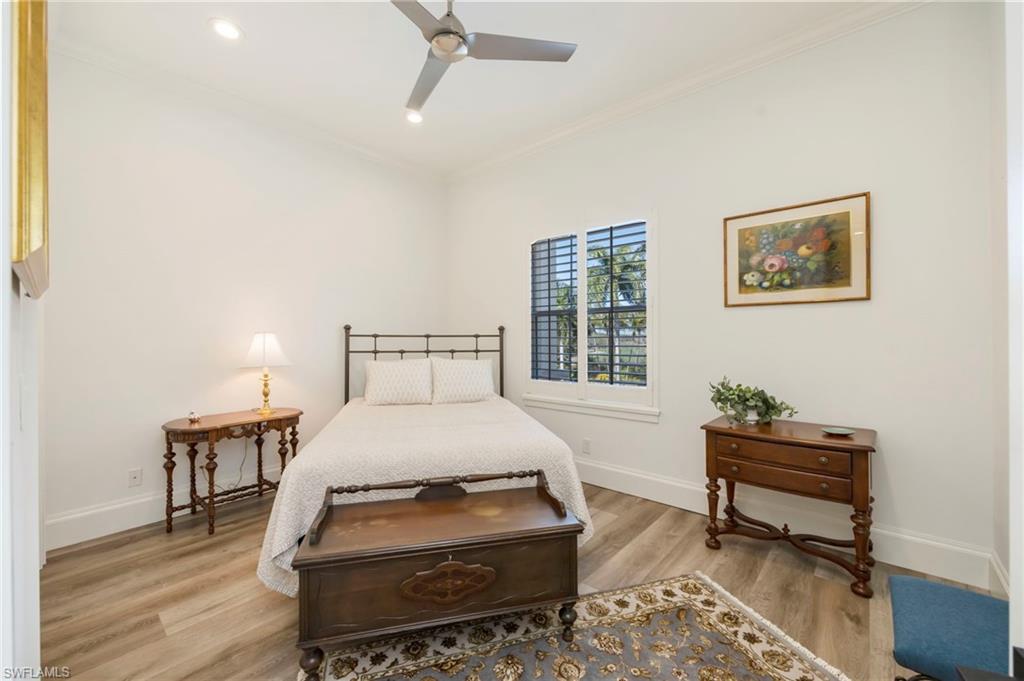 2870 Castillo Court, Unit 103 Naples, FL 34109 - Photo 16 of 34 a bedroom with a bed and a window