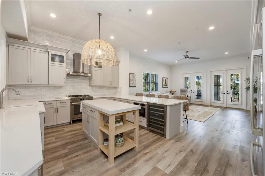 2870 Castillo Court, Unit 103 Naples, FL 34109 - Photo 2 of 34 an open kitchen with a stove and white cabinets