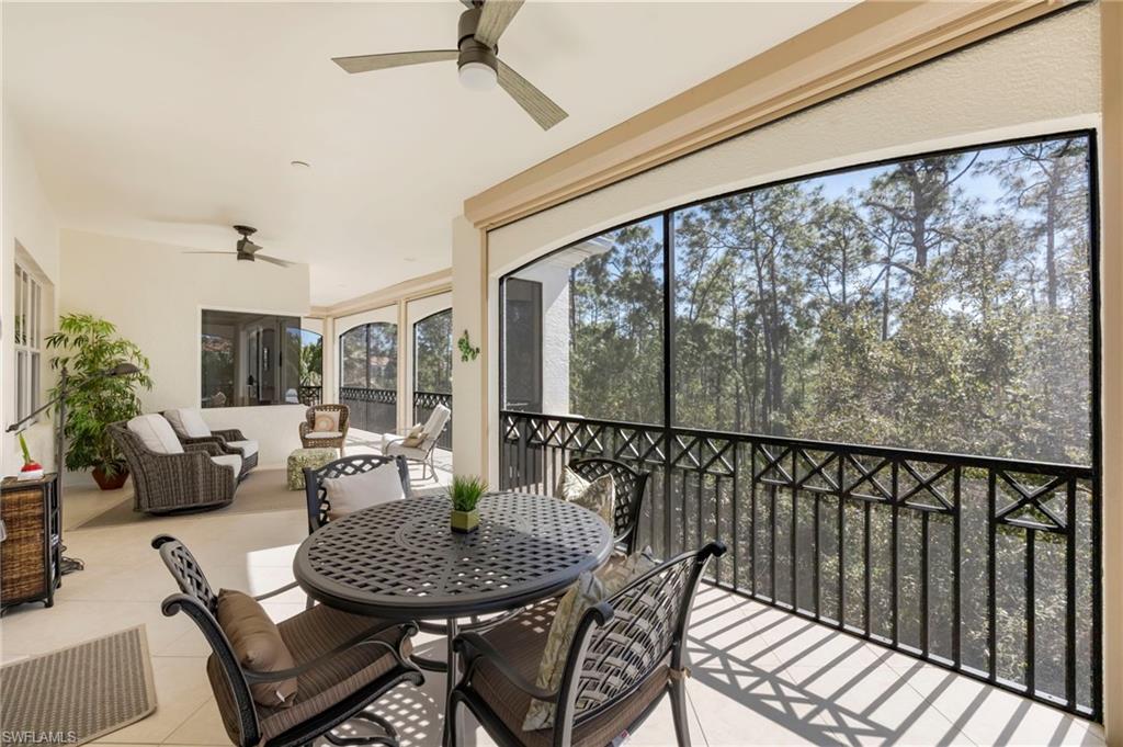 2870 Castillo Court, Unit 103 Naples, FL 34109 - Photo 22 of 34 a living room with furniture and a large window