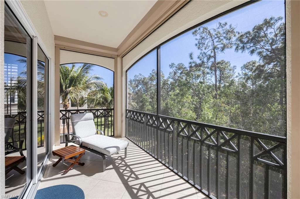 2870 Castillo Court, Unit 103 Naples, FL 34109 - Photo 23 of 34 a balcony view with a large window and chairs