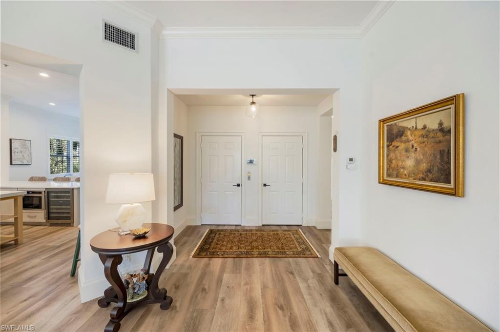 2870 Castillo Court, Unit 103 Naples, FL 34109 - Photo 24 of 34 a living room with furniture and wooden floor