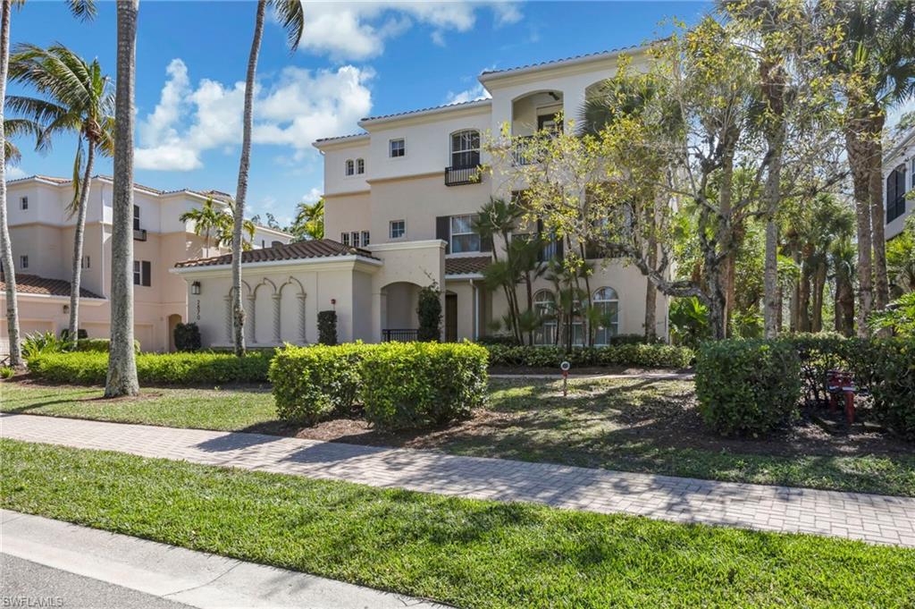 2870 Castillo Court, Unit 103 Naples, FL 34109 - Photo 28 of 34 a view of a front of a house with a yard