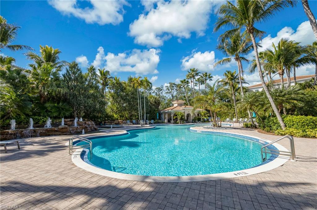 2870 Castillo Court, Unit 103 Naples, FL 34109 - Photo 30 of 34 a view of a swimming pool with a yard