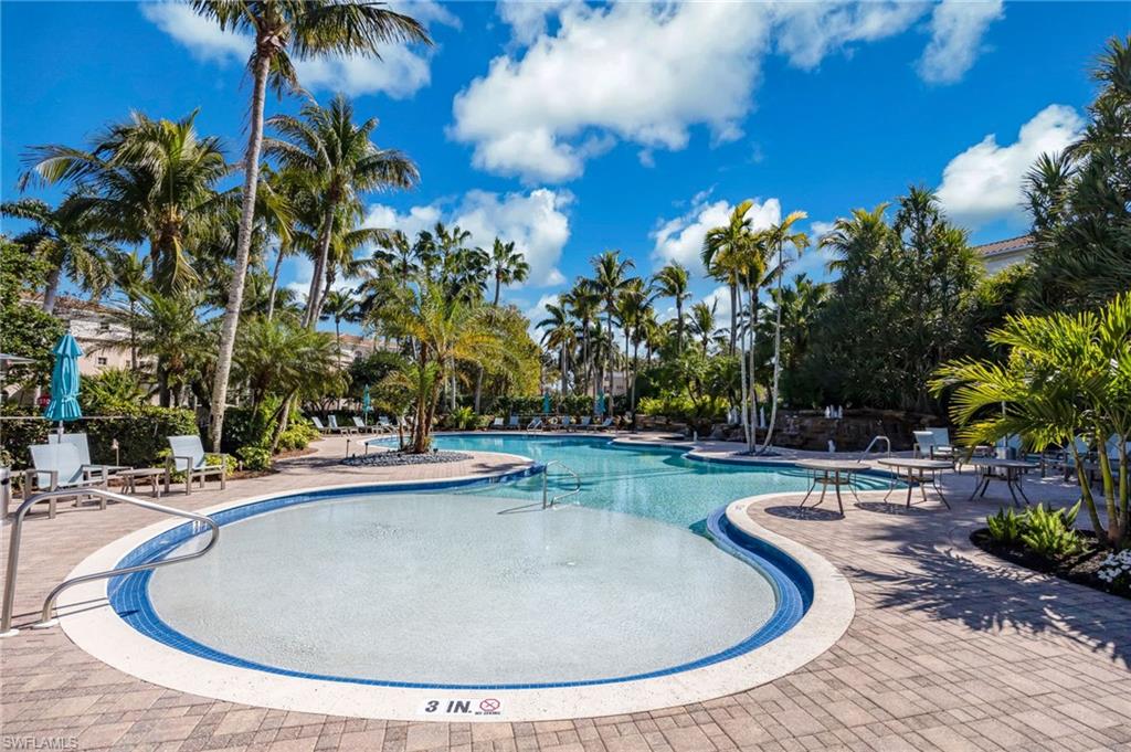 2870 Castillo Court, Unit 103 Naples, FL 34109 - Photo 31 of 34 a view of a swimming pool with a garden