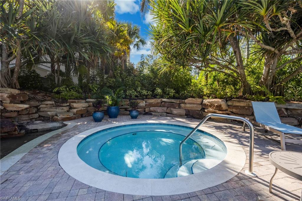 2870 Castillo Court, Unit 103 Naples, FL 34109 - Photo 32 of 34 a view of swimming pool from a lounge chair