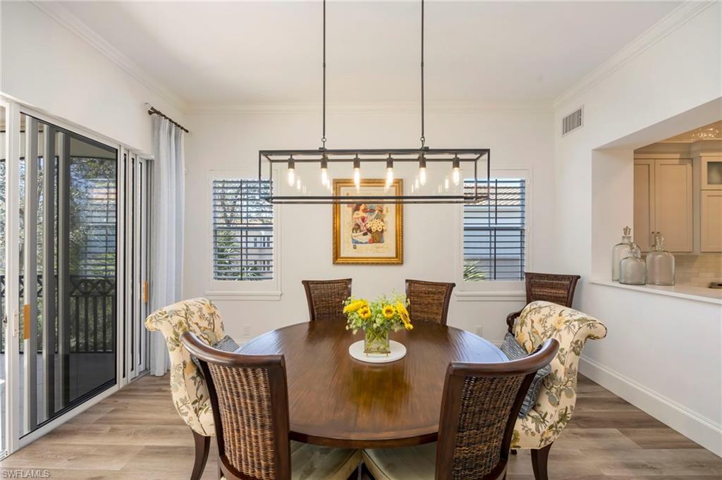 2870 Castillo Court, Unit 103 Naples, FL 34109 - Photo 8 of 34 a view of a dining room with furniture window and outside view