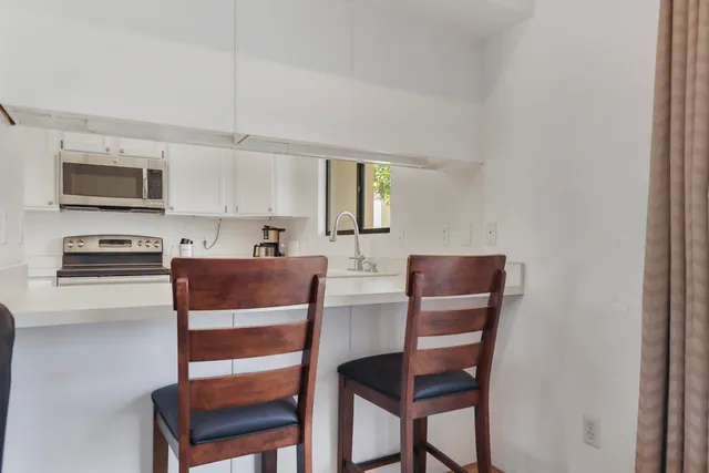 a kitchen with stainless steel appliances a stove top oven a sink and a microwave