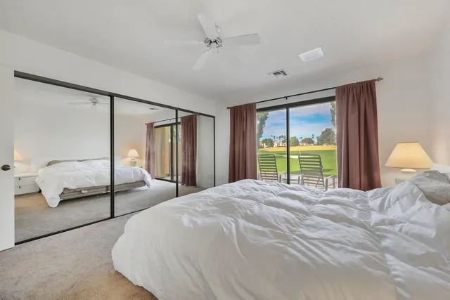 a bedroom with a large bed and a large window
