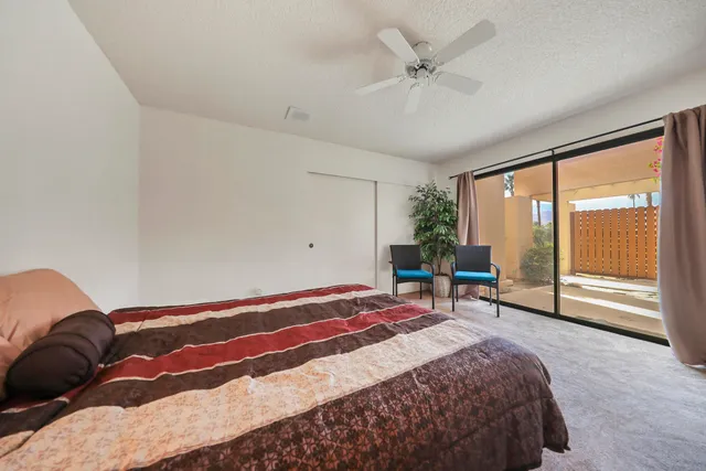 a bedroom with a bed a table and window