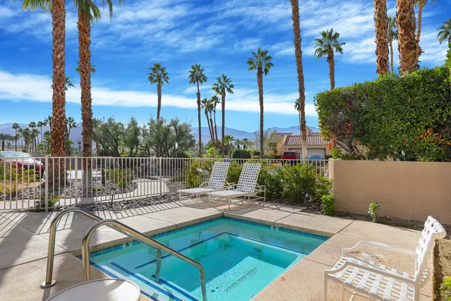 a view of a patio with a table chairs and a fire pit