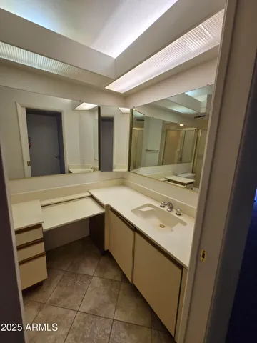 a bathroom with a sink a mirror and a bathtub
