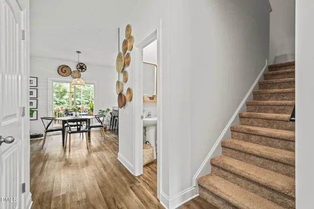 a bedroom with a bed a chandelier and a dresser