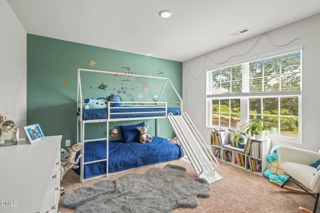 a bedroom with a bed and a couch