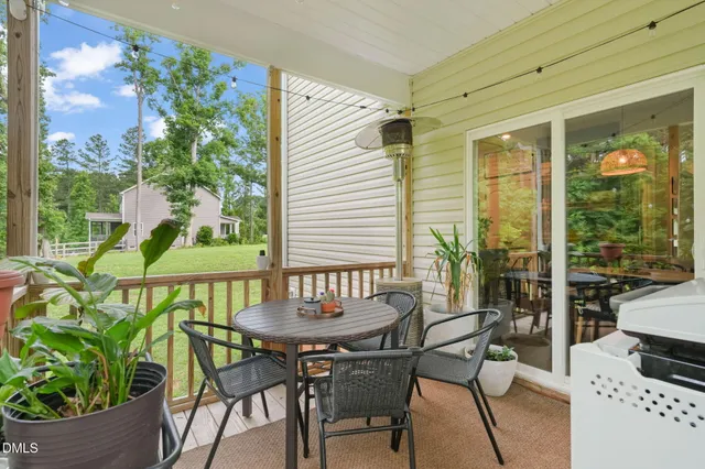 a view of a house with backyard and a tree