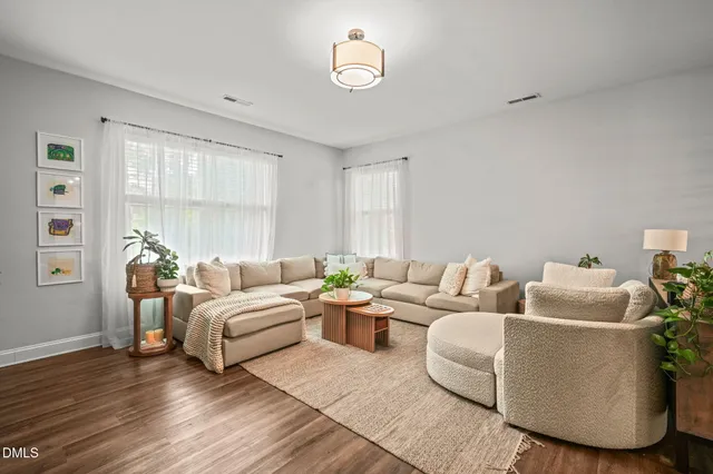 a living room with furniture and a potted plant