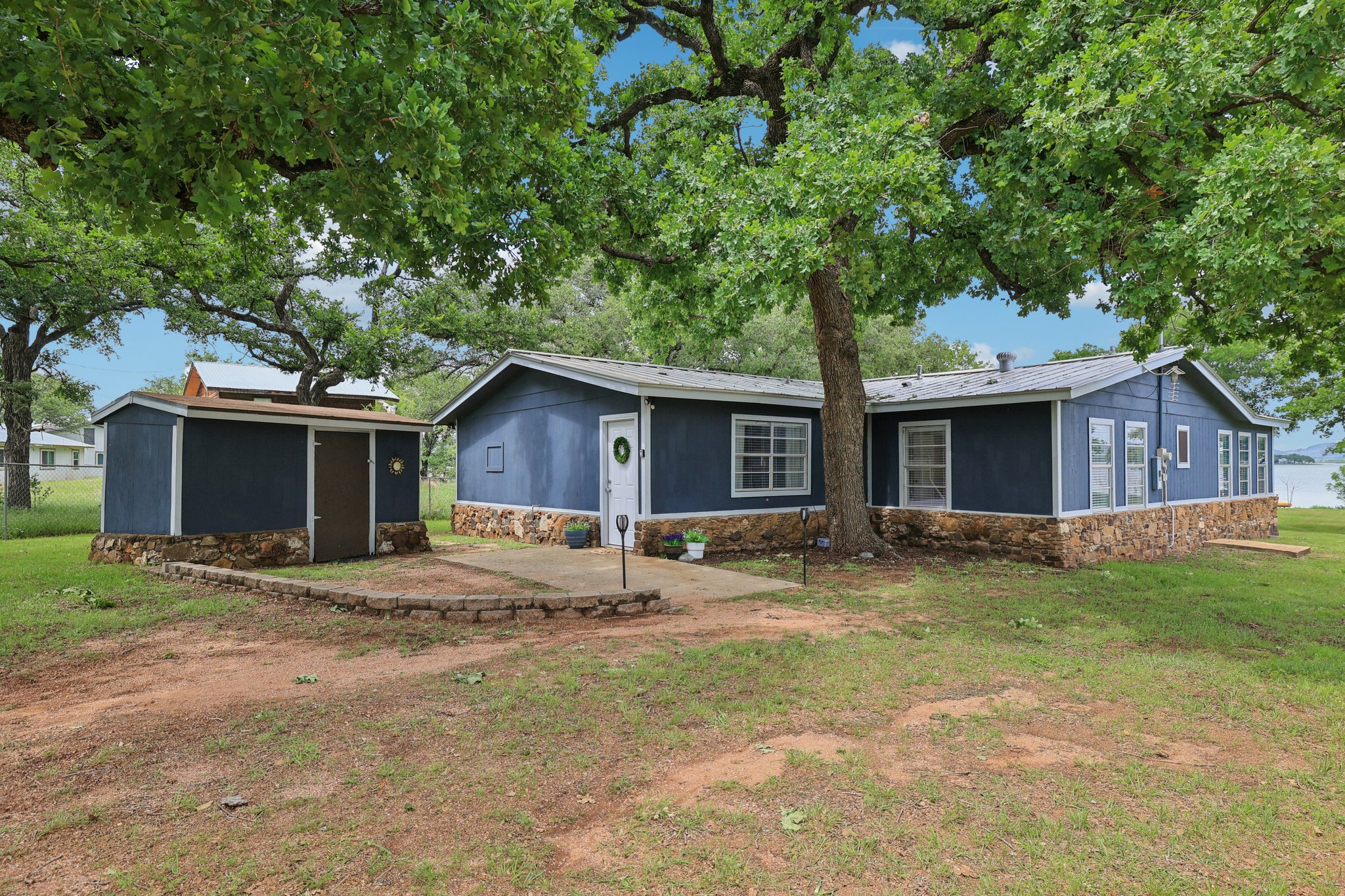 a house that has a tree in front of it