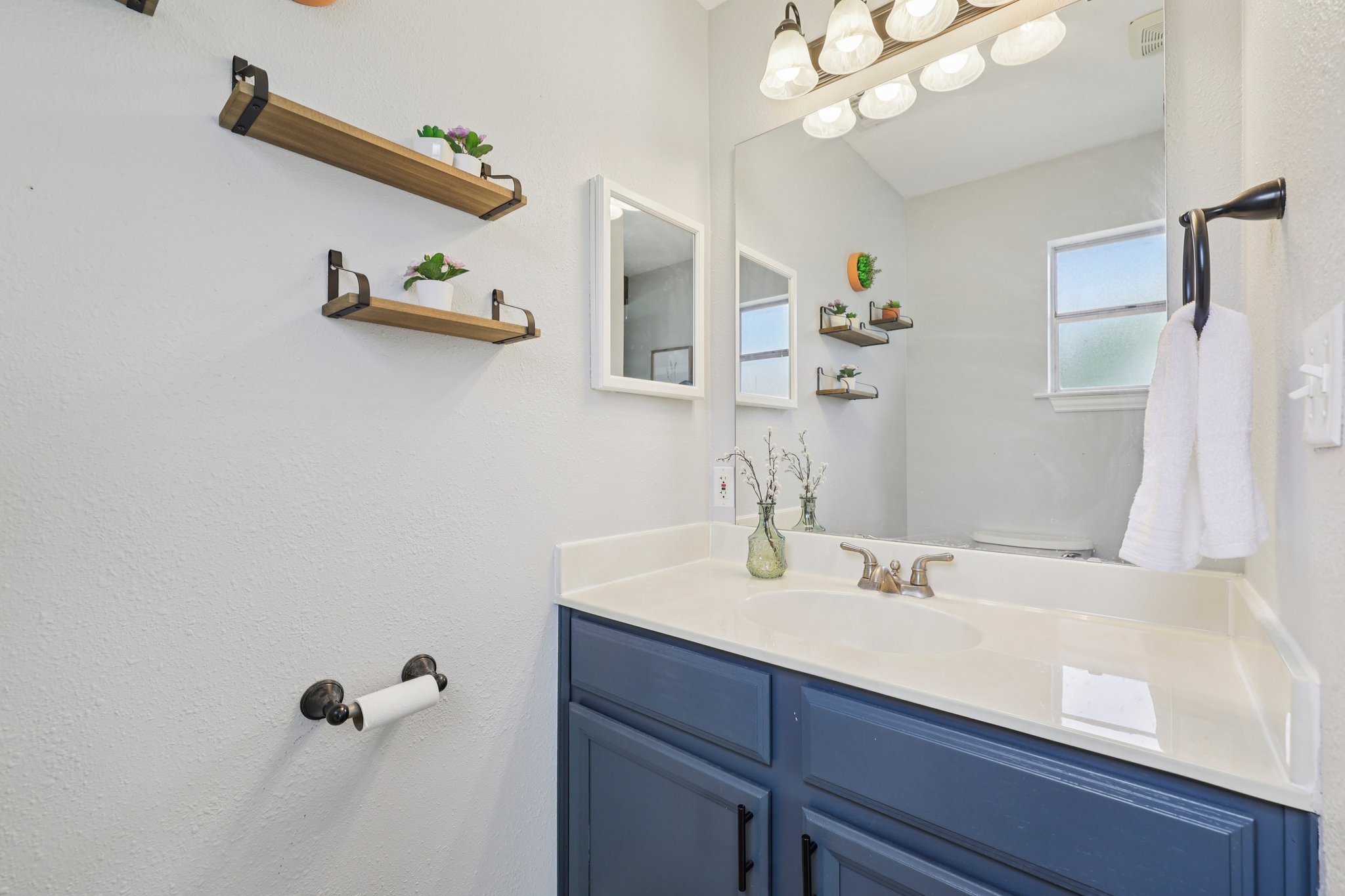 145 Oak Point Tow, TX 78672 - Photo 12 of 29 a bathroom with a sink and a mirror