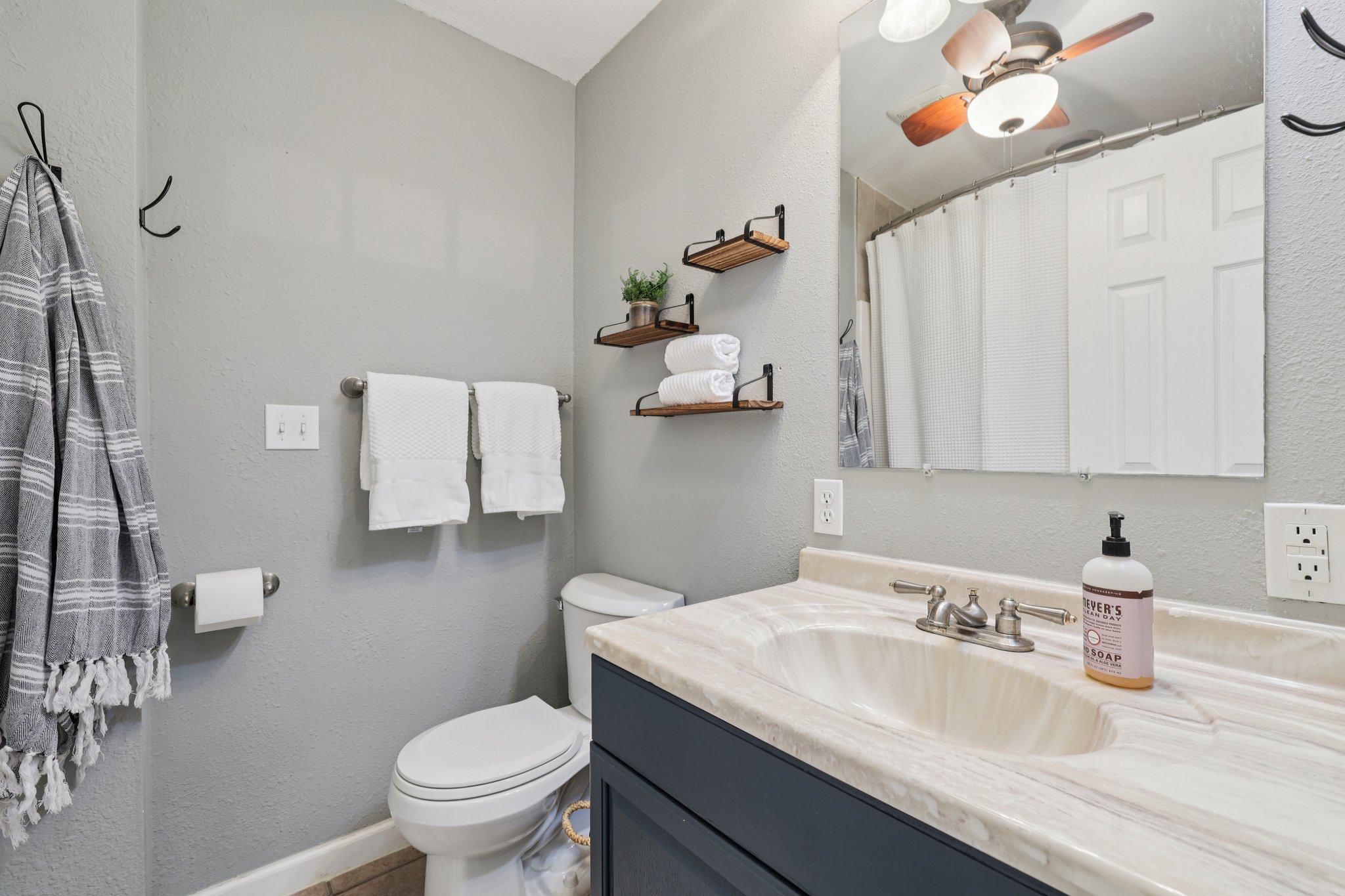 145 Oak Point Tow, TX 78672 - Photo 14 of 29 a bathroom with a toilet sink and mirror