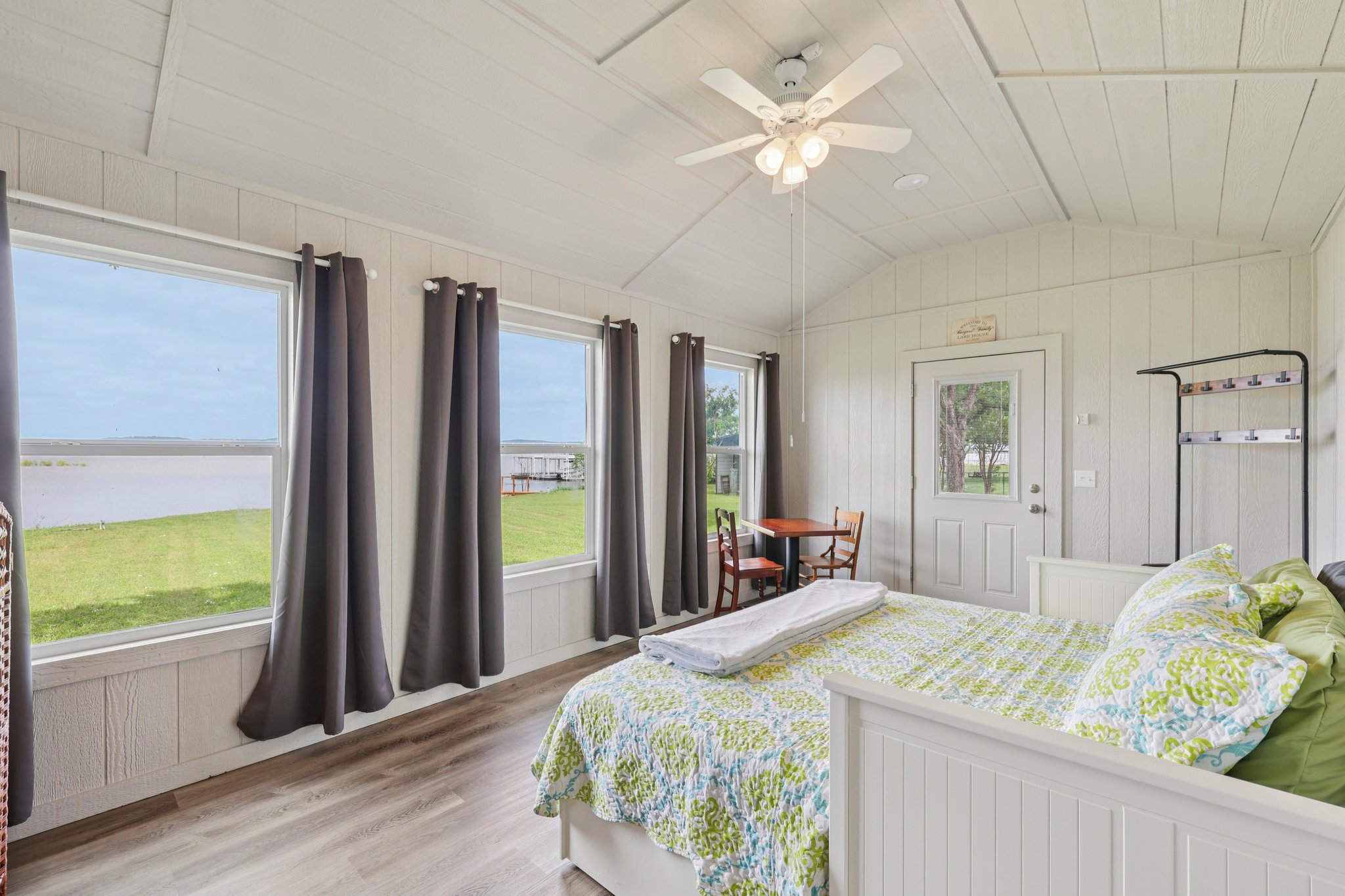 145 Oak Point Tow, TX 78672 - Photo 18 of 29 a bedroom with a bed and a large window with balcony view