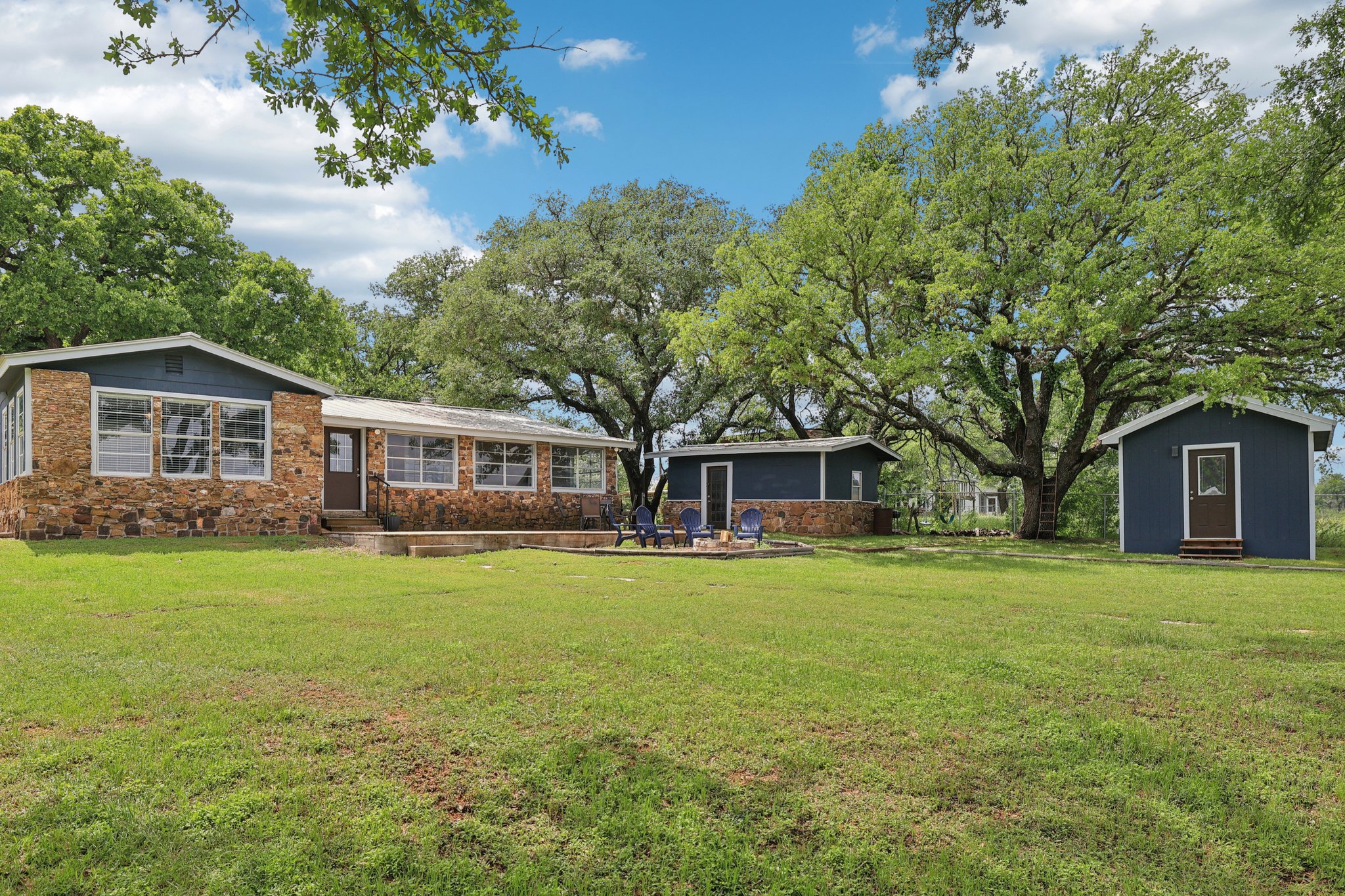 145 Oak Point Tow, TX 78672 - Photo 24 of 29 a front view of a house with a garden