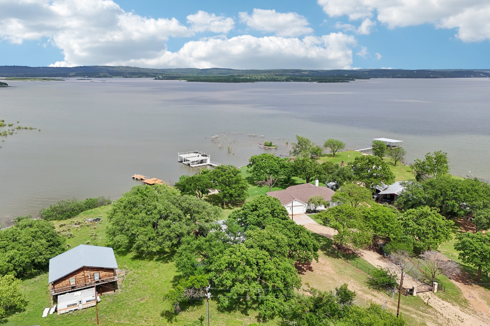 145 Oak Point Tow, TX 78672 - Photo 26 of 29 an aerial view of a house with a yard and lake view