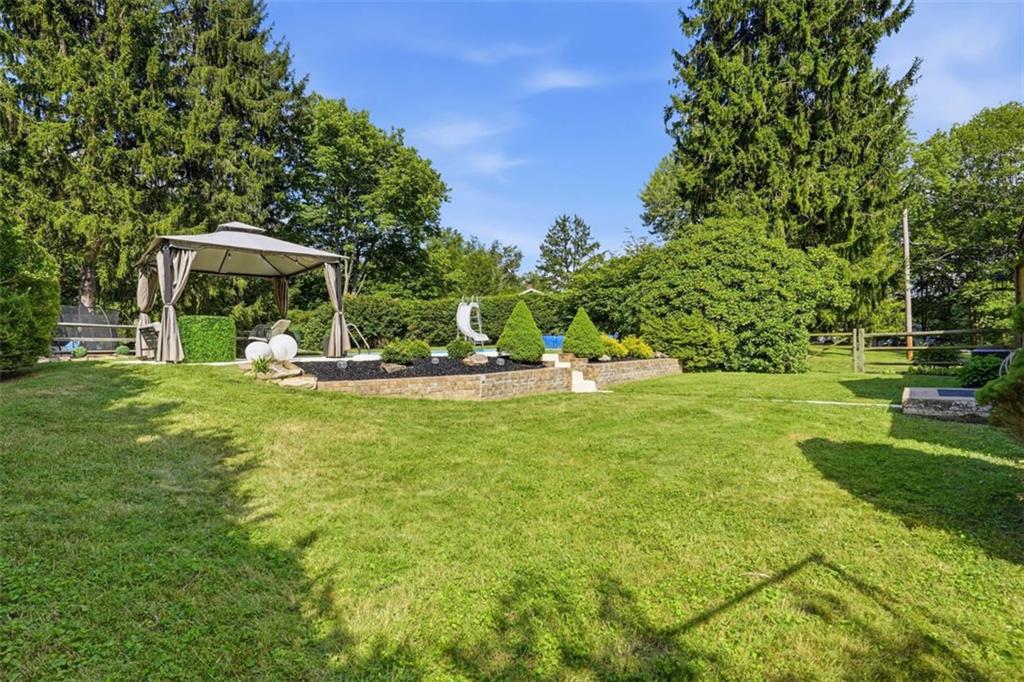5520 Clearview Road Gibsonia, PA 15044 - Photo 31 of 48 Outside, the entertaining possibilities continue with a sprawling yard featuring a brick retaining wall with steps leading to an in-ground pool and a covered gazebo perfect for lounging or dining.