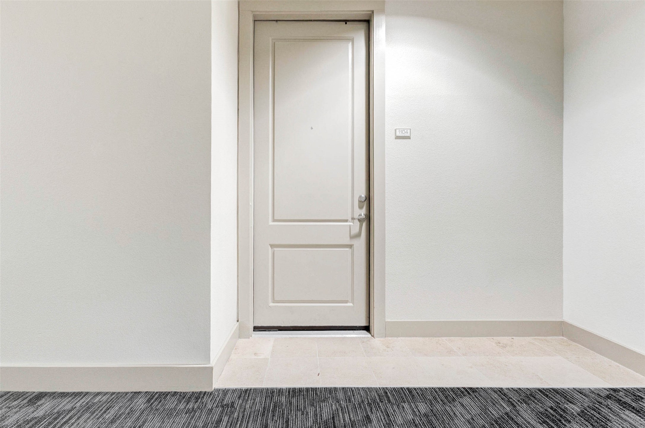 3505 Sage Road, Unit 1104 Houston, TX 77056 - Photo 5 of 31 Arrive at Unit 1104 through a quiet and well-kept residential hallway. The private entry welcomes you home with a clean, simple aesthetic that reflects the modern feel of The Mark. Located on the 11th floor, this residence offers convenient elevator access and a peaceful setting above the vibrant Galleria district. From the moment you step up to the front door, you’ll appreciate the secure, well-maintained environment that makes high-rise living both comfortable and convenient.