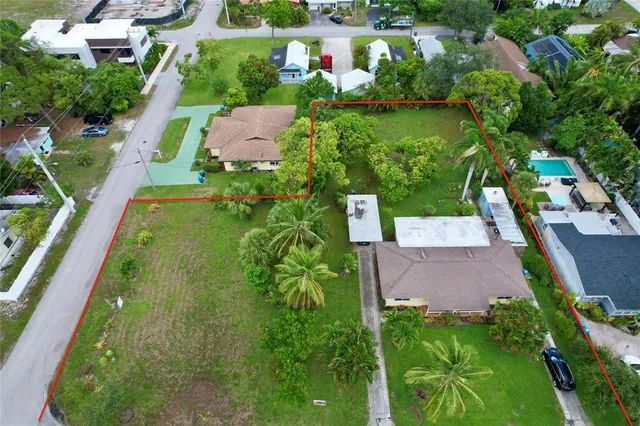 an aerial view of residential houses with outdoor space and street view