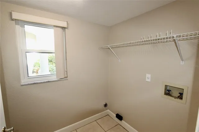 a bathroom with a window and a shower