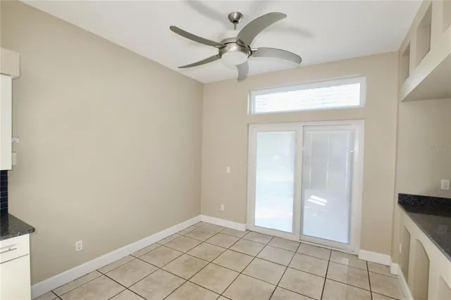 a view of an empty room and a bathroom