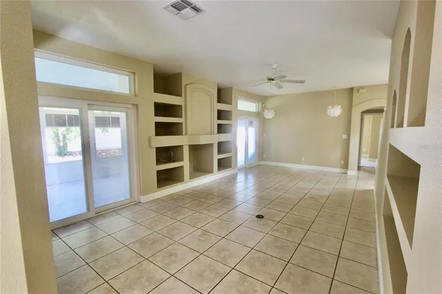 a view of a house with backyard and a tree