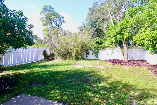 an empty room with a window and a ceiling fan