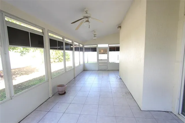 an empty room with closet and a ceiling fan