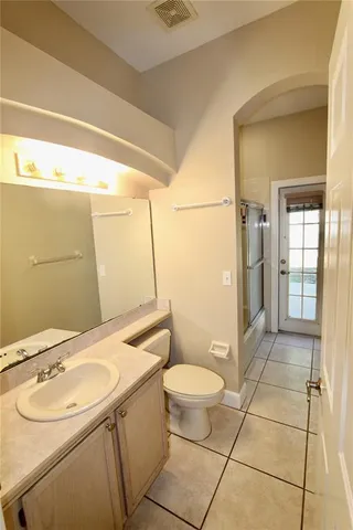 a bathroom with a sink mirror toilet and shower