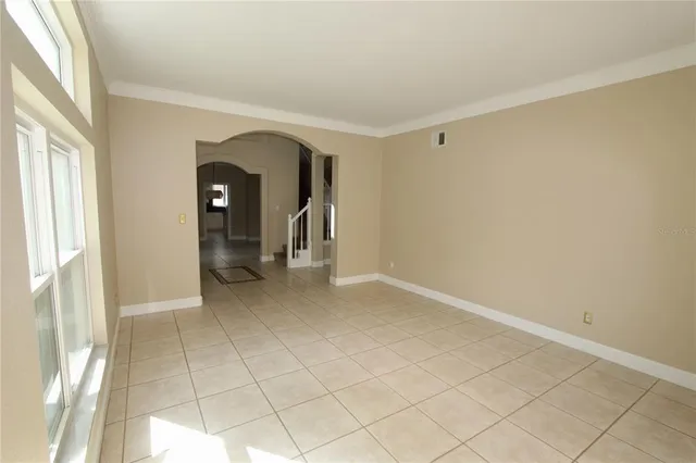 an empty room with a ceiling fan and a window