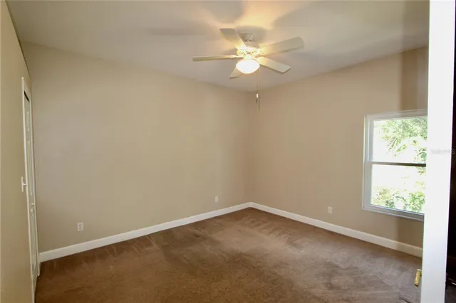 an empty room with windows and closet