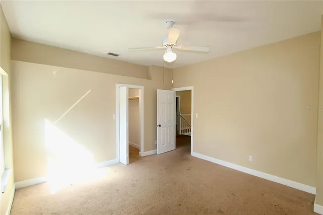 a view of a livingroom with a ceiling fan and window