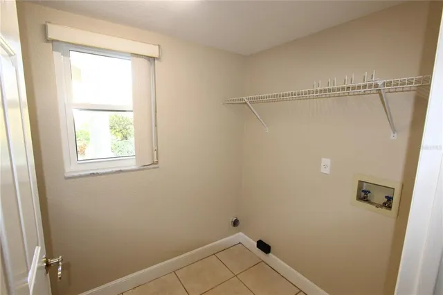 a view of a room with rack on the wall and a window