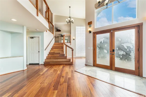 a view of a hallway with wooden floor and staircase