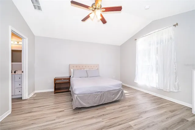 a room with a bed and wooden floor
