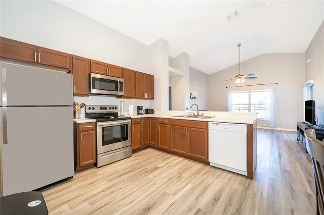a kitchen with a refrigerator stove and white cabinets