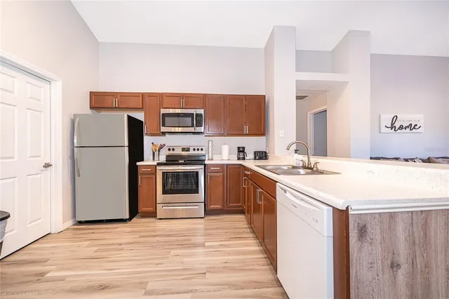 a kitchen with stainless steel appliances kitchen island a refrigerator sink and stove
