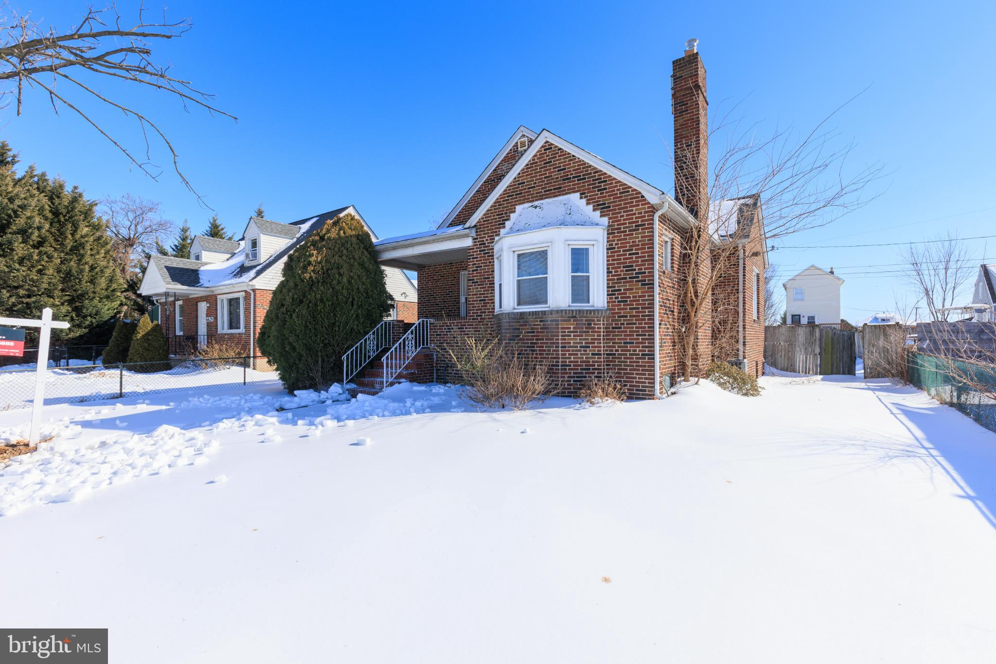 Charming brick home in a winter wonderland.