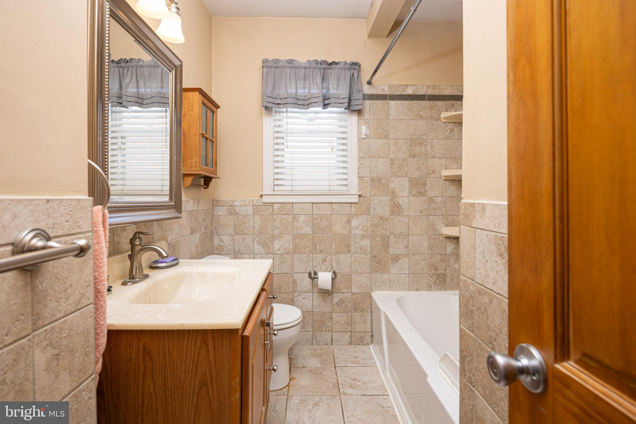 6627 Bushey Street Baltimore, MD 21224 - Photo 15 of 33 Charming bathroom with elegant tile accents.