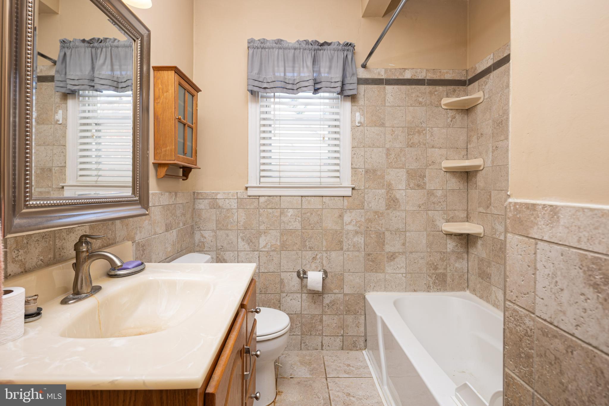 6627 Bushey Street Baltimore, MD 21224 - Photo 16 of 33 Charming bathroom with elegant tile accents.