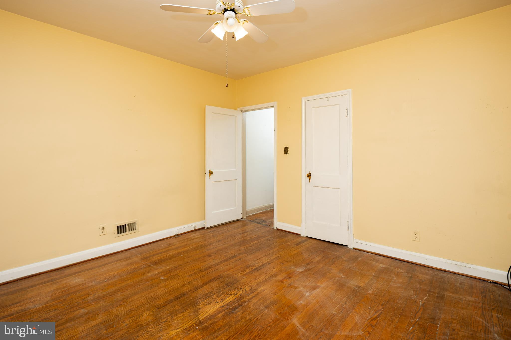 6627 Bushey Street Baltimore, MD 21224 - Photo 19 of 33 Spacious room with warm, inviting tones.