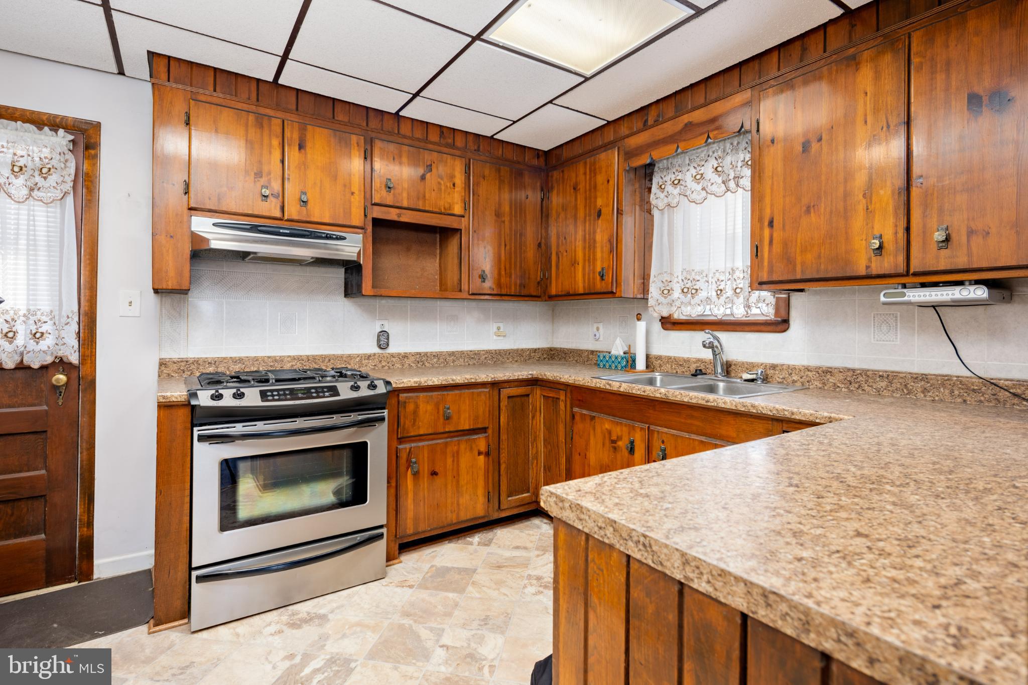 6627 Bushey Street Baltimore, MD 21224 - Photo 2 of 33 Warm wooden kitchen with modern appliances.