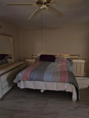 a bedroom with a bed and a night stand