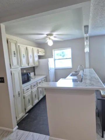 a kitchen with cabinets and window