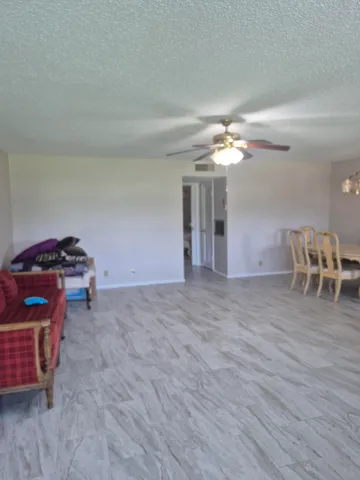 a view of a livingroom with furniture and chandelier